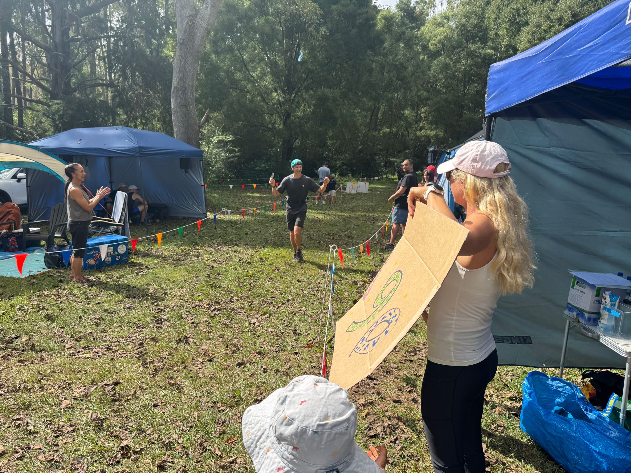 Tim Dove coming in on lap 10, crew cheering at the tent